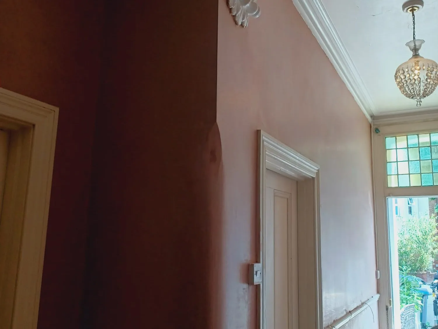 Replastered entrance hall walls after damp treatment