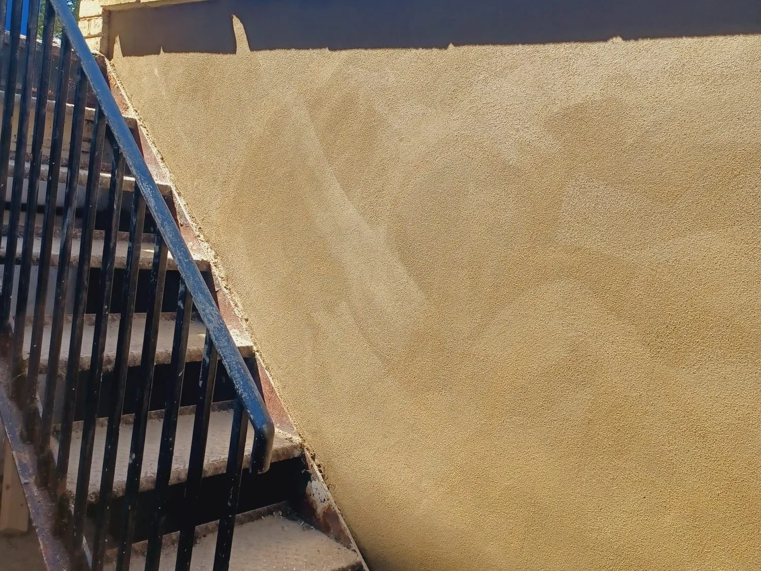 Newly rendered external stairwell wall
