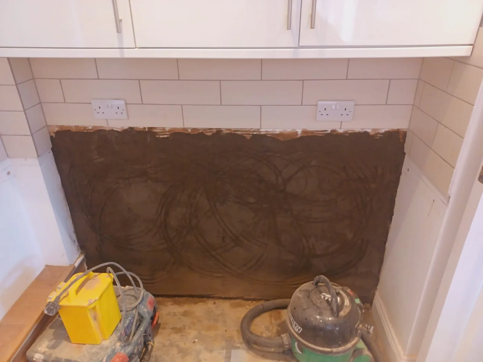 Damp proof render coat being applied to an internal wall