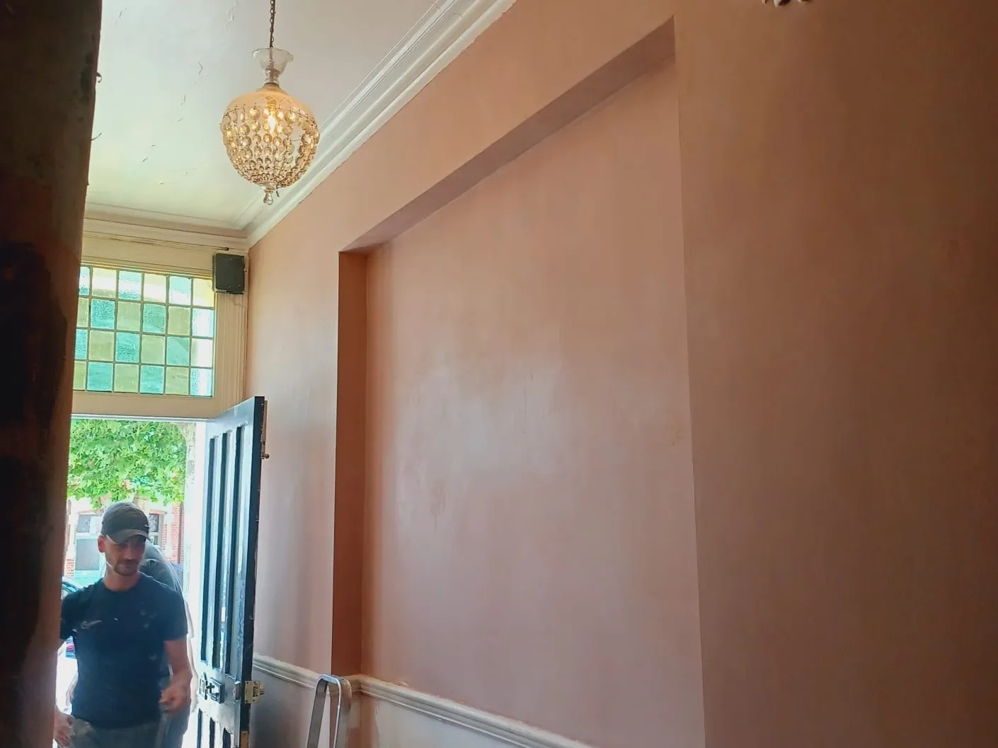 Plastering in progress on a wall following damp proofing works