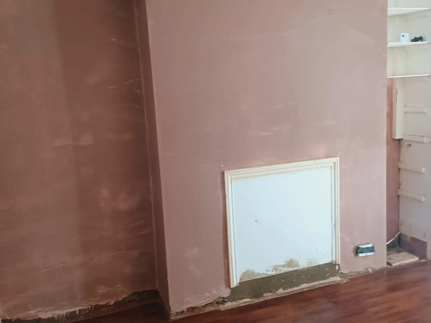 Newly plastered hallway after remedial damp work