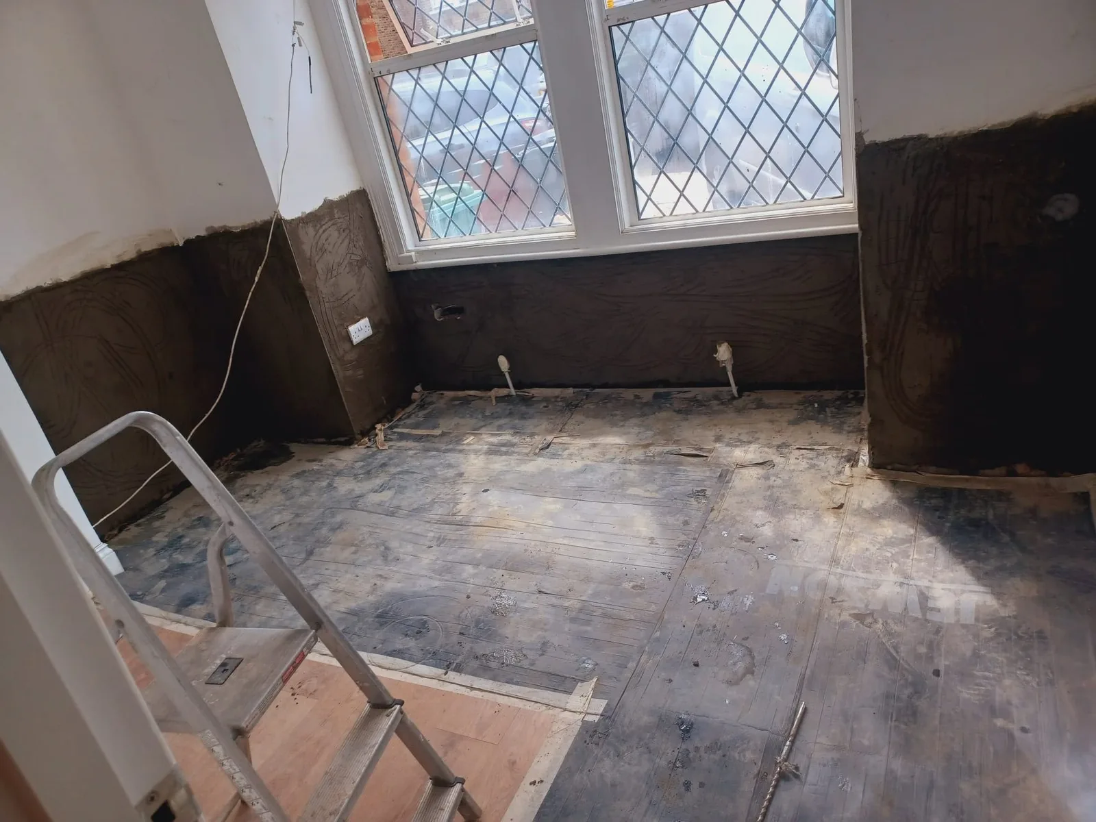 Damp proofing membrane and treatment in progress on a ground floor wall